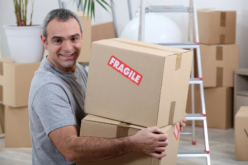 Moving van loading boxes beside a Richmond townhouse