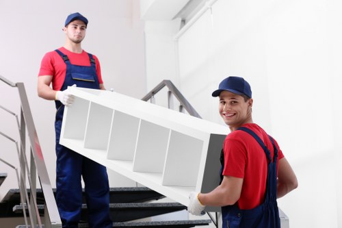 Team member loading boxes carefully with protective moving equipment