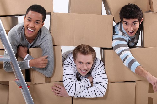 Professional movers carrying furniture during a Richmond house move