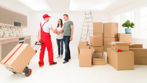 Packed moving boxes and furniture being loaded into a van in Richmond